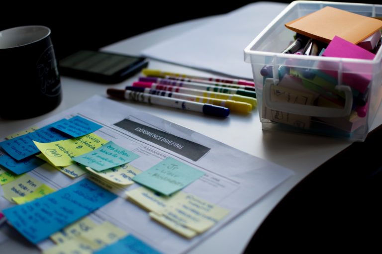 a desk with papers and pens