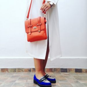a person wearing a red purse and a red purse