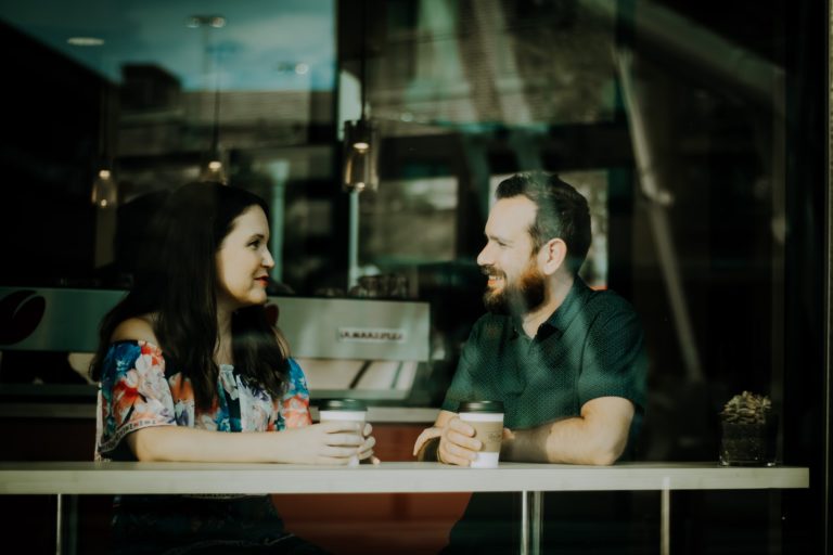 a man and woman sitting at a table