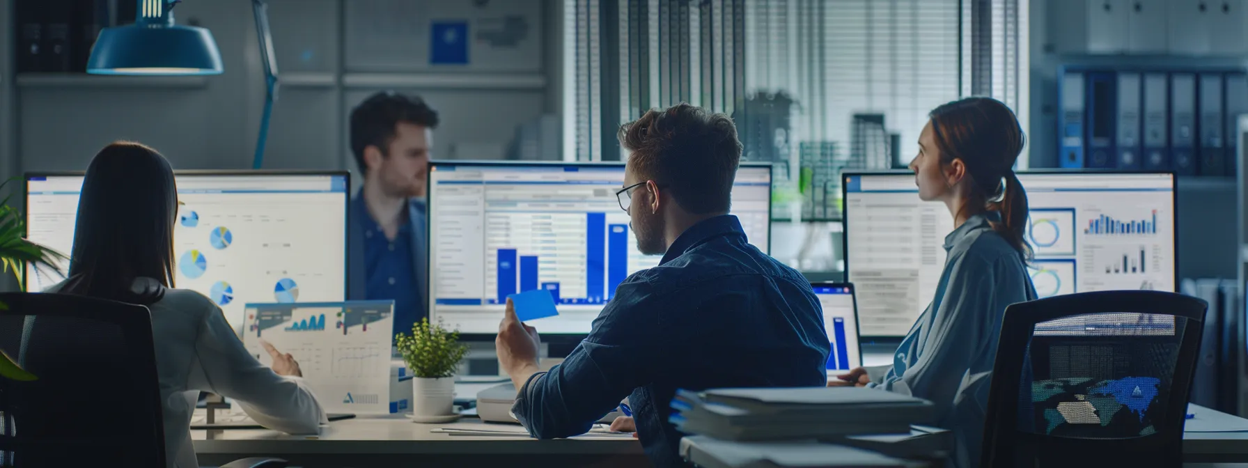 a team of digital marketers analyzing data on computer screens in a modern office setting.